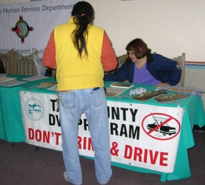 Summit attendee viewing resources at the Taos County DWI program table