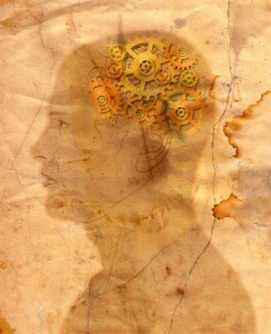 Faded drawing of man's head in profile, on old-looking, stained paper. The "brain area" is filled with gears.